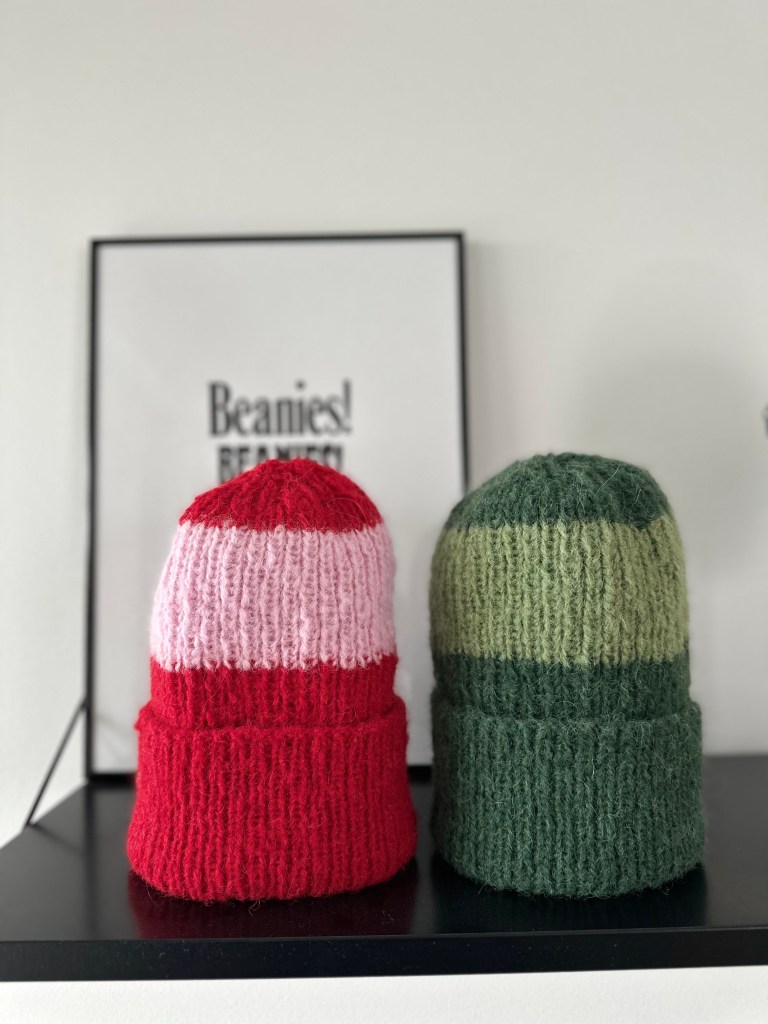 Kaksi raidallista Colouriche pipoa, toinen punaraidallinen ja toinen vihreäraidallinen